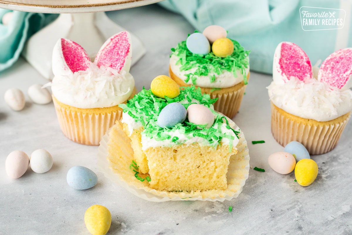 Easter cupcake cut in half with green coconut and chocolate Cadberry eggs.