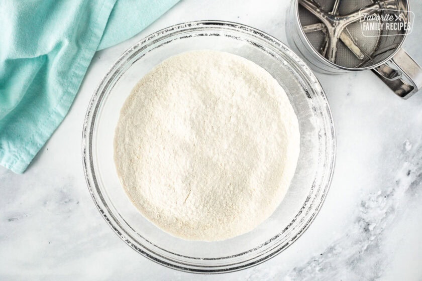 Sifted dry ingredients in a glass mixing bowl.