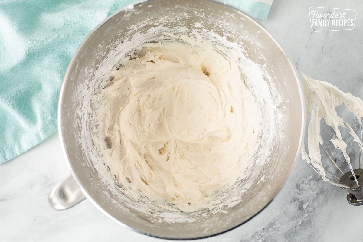 Cream cheese frosting for Easter cupcakes in a mixing bowl.