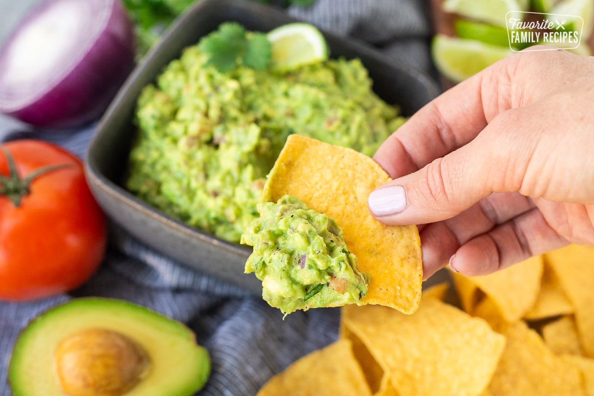 Holding a chip that has been dipped in guacamole