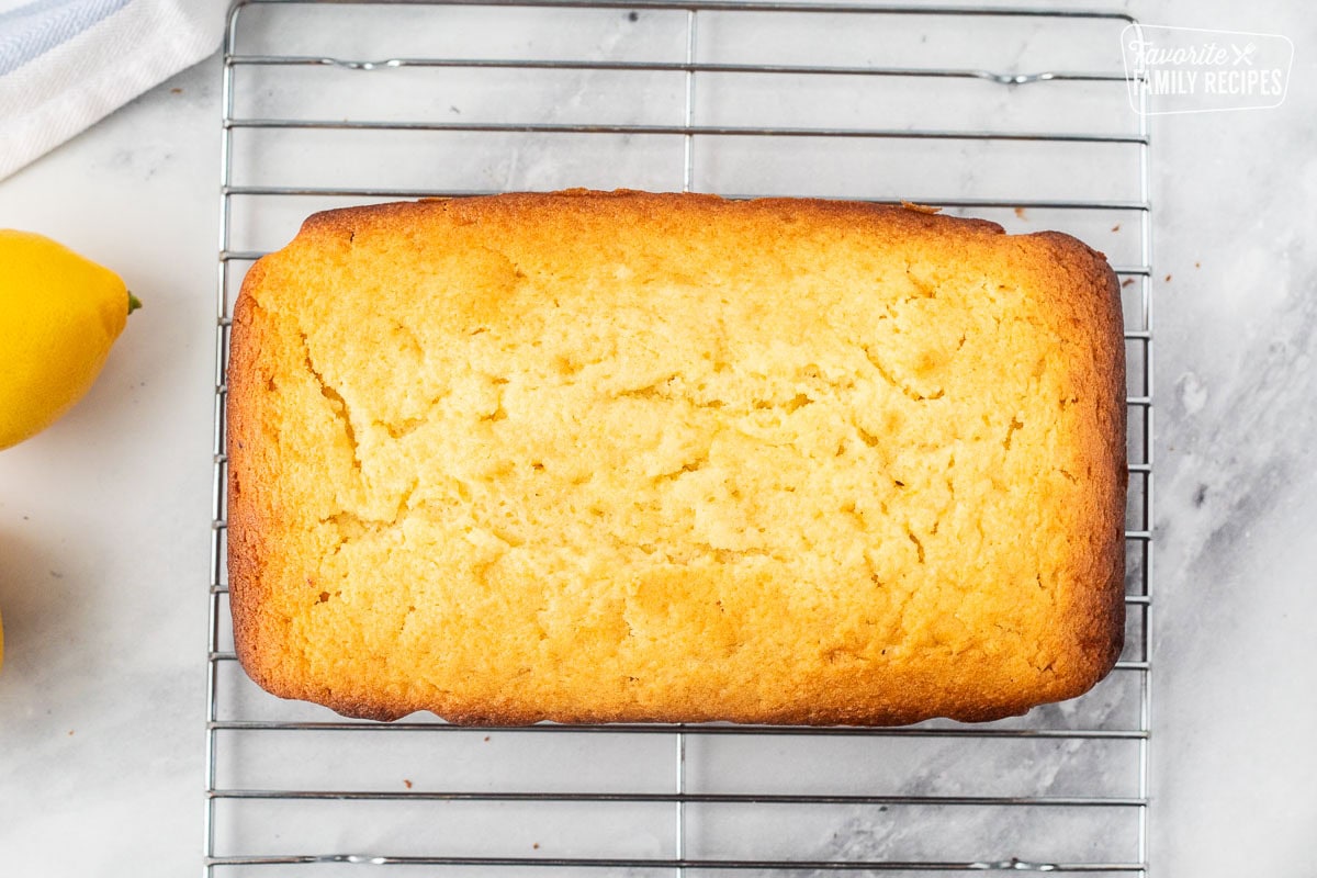 Baked lemon pound cake cooling on a rack.