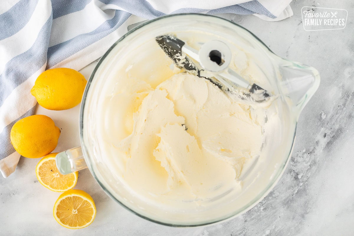 Glass mixing bowl with creamed butter and sugar.