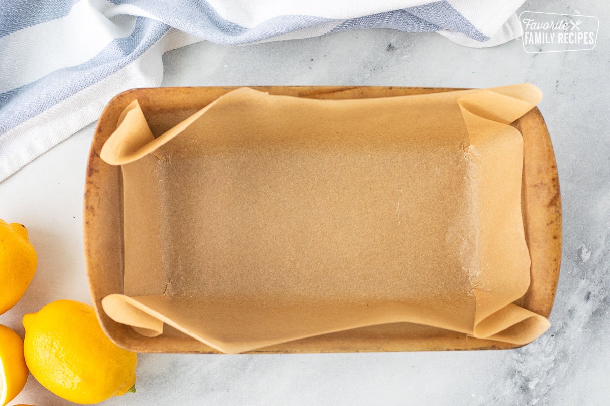 Loaf pan lined with parchment paper.