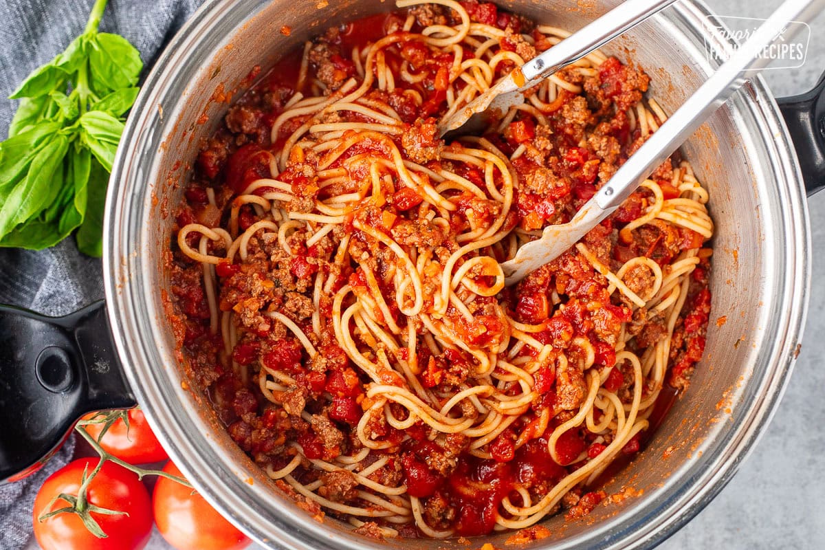 Tossing spaghetti pasta with Nick's Authentic Italian sauce.