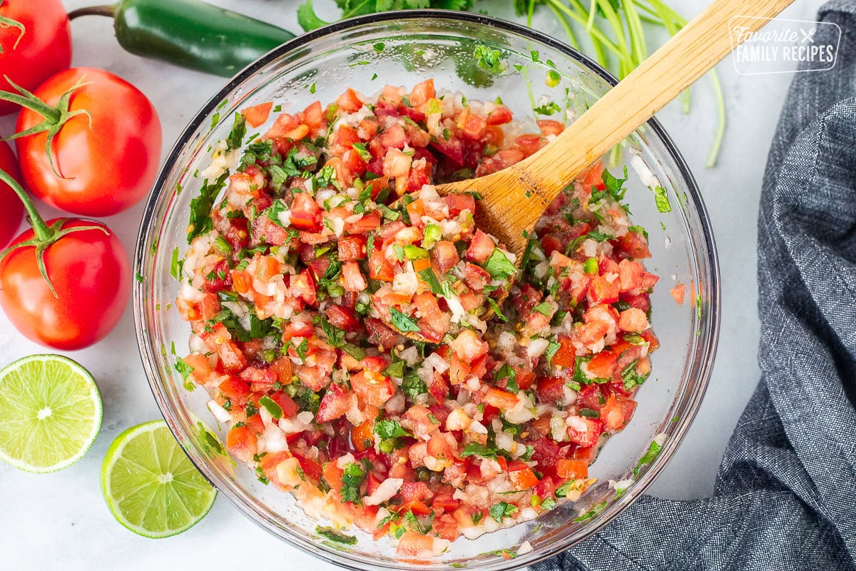 Glass mixing bowl with fresh mixed Pico de Gallo.