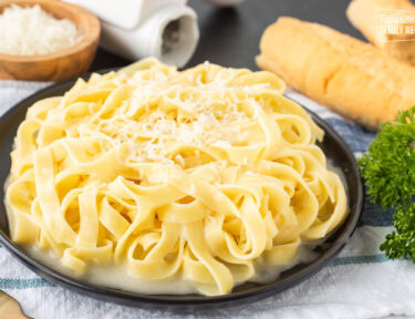 Plate of Authentic Fettuccine Alfredo with fresh grated Parmigiana Reggiano cheese.