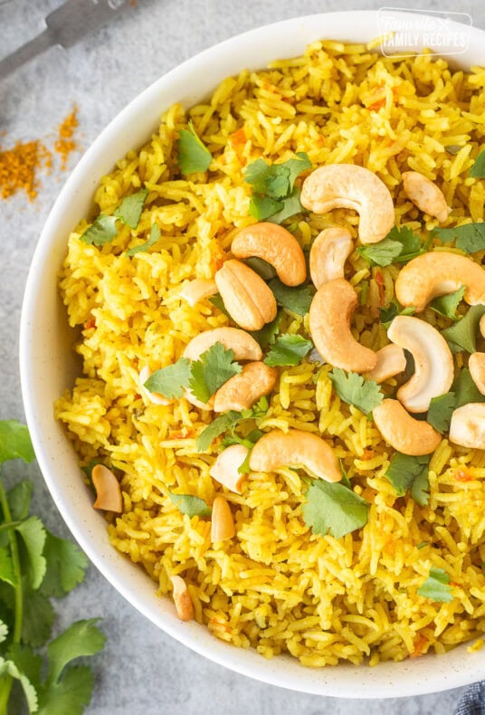 Bowl of coconut rice with cashews and cilantro.