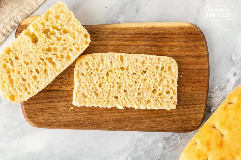 Sliced ciabatta bread on a cutting board.