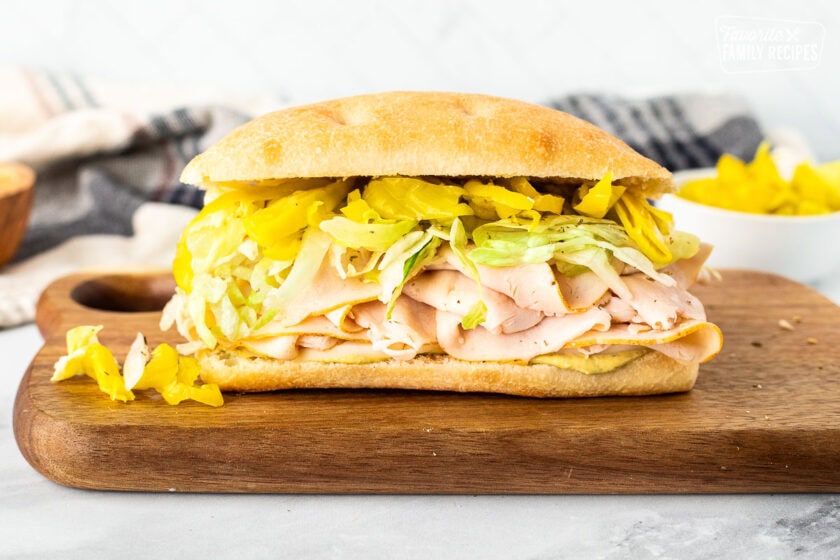 Italian turkey sandwich with pesto mayo, cheese, turkey, peppers and lettuce.