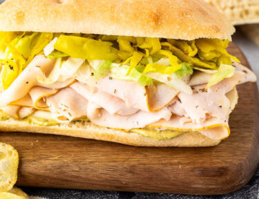 Italian turkey sandwich with pesto mayo, cheese, turkey, peppers and lettuce.