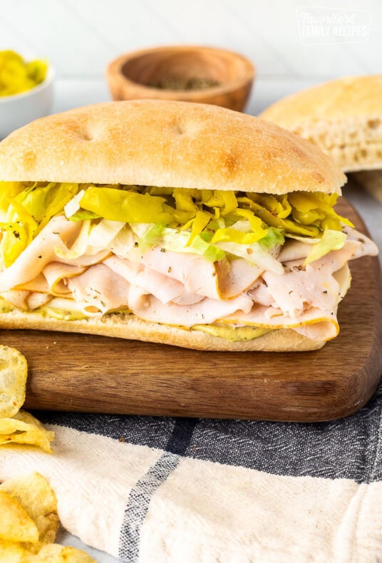 Italian turkey sandwich with pesto mayo, cheese, turkey, peppers and lettuce.