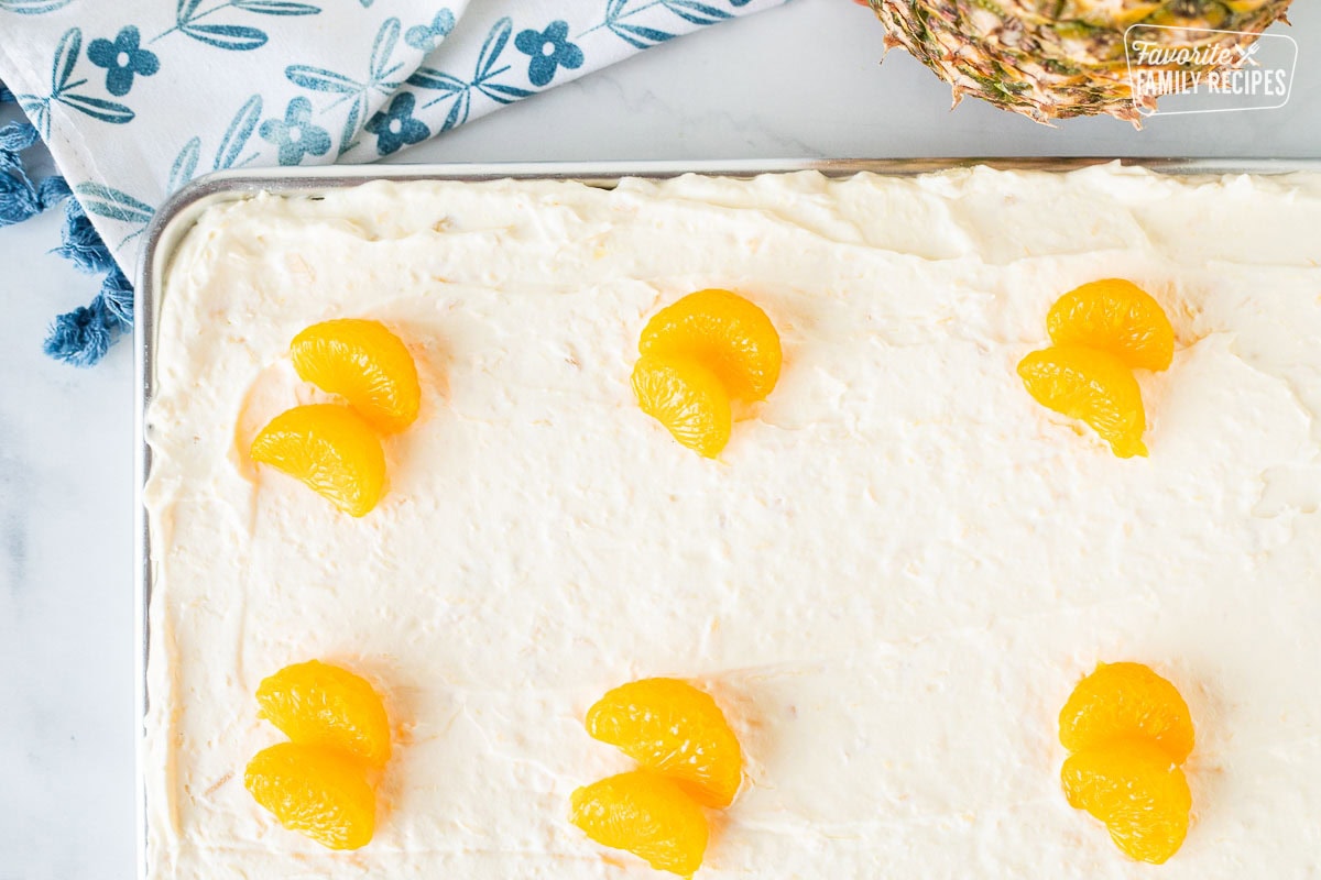 Orange pineapple cake topped with mandarin oranges.