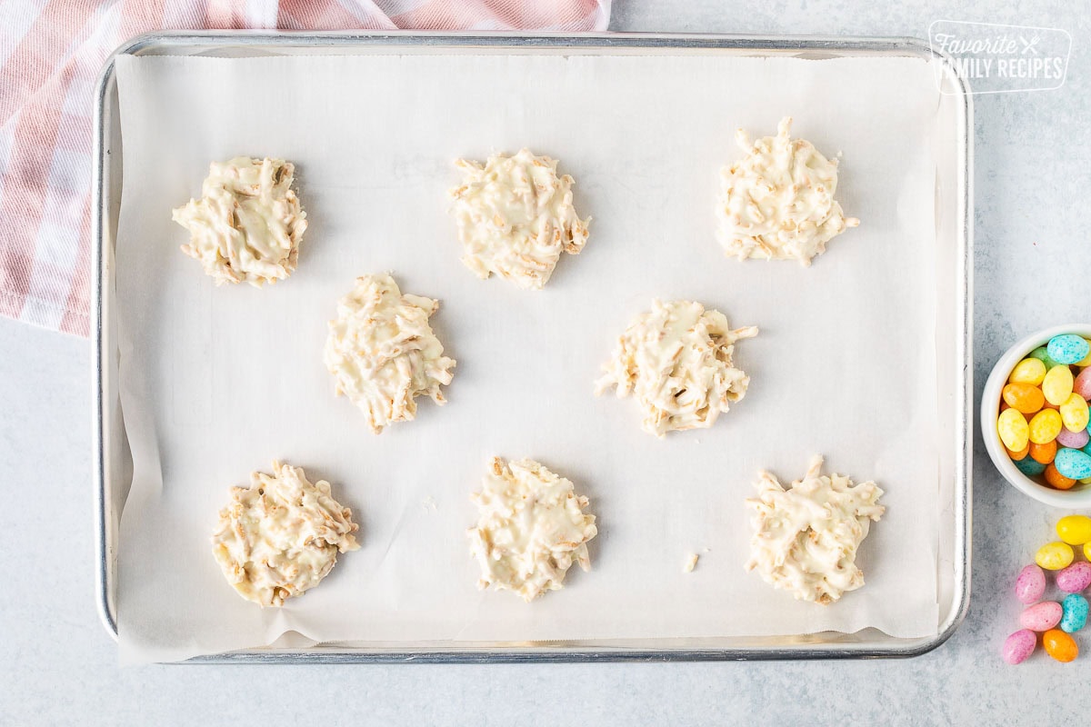 Cookie sheet with small stacks of white chocolate nests.